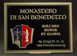 Plaque with shield logo filled with blue and red