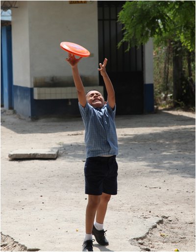 Boy catching orange flying disc