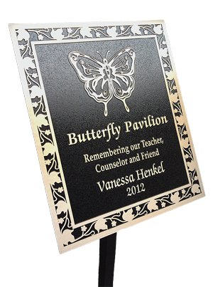 Black plaque with butterfly on display stake
