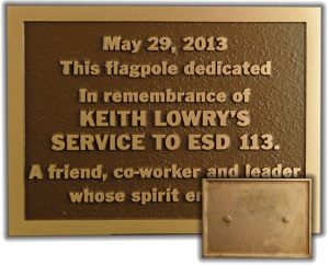 A bronze plaque with inset view of welded studs on back for easy mounting