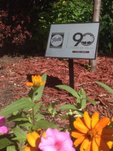 Small Pella Corporation plaque on display stake in garden