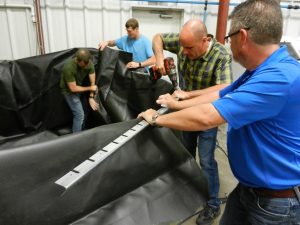 PEC co-owners working together on zinc tank