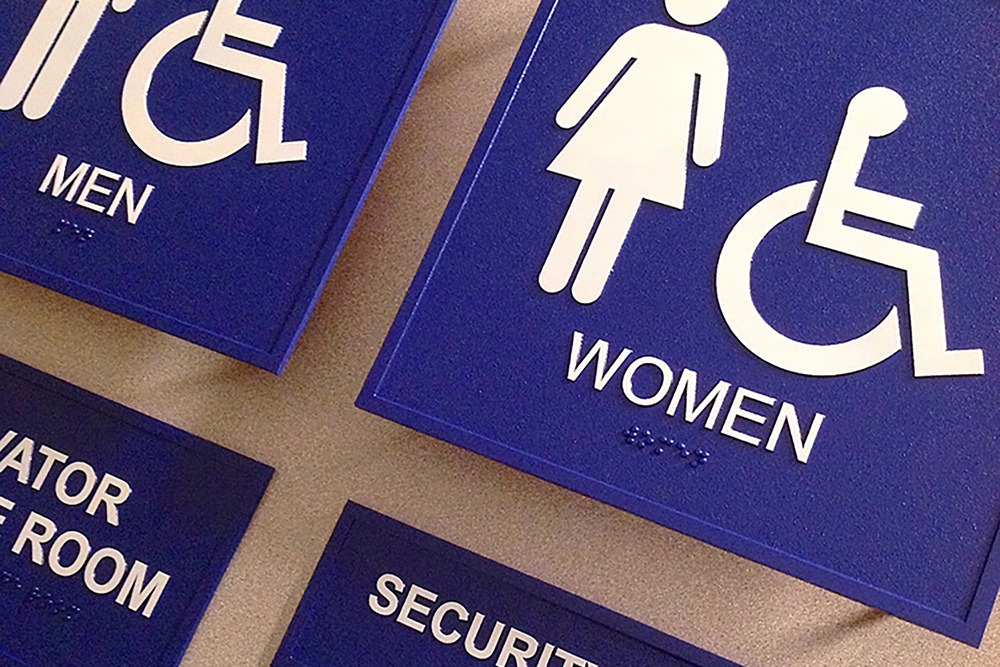 Blue and white restroom signs