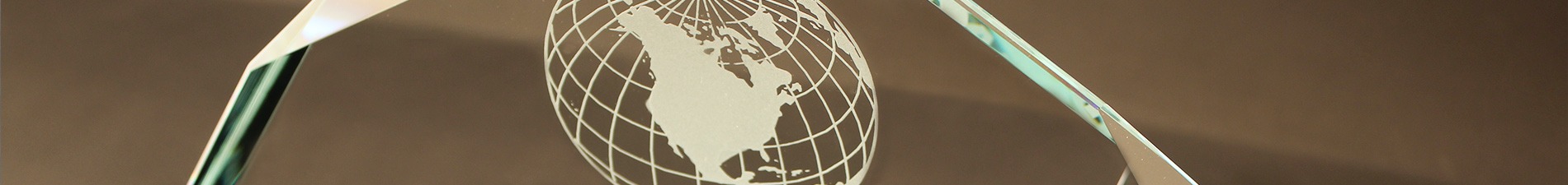 Header image closeup of sandcarved award with globe