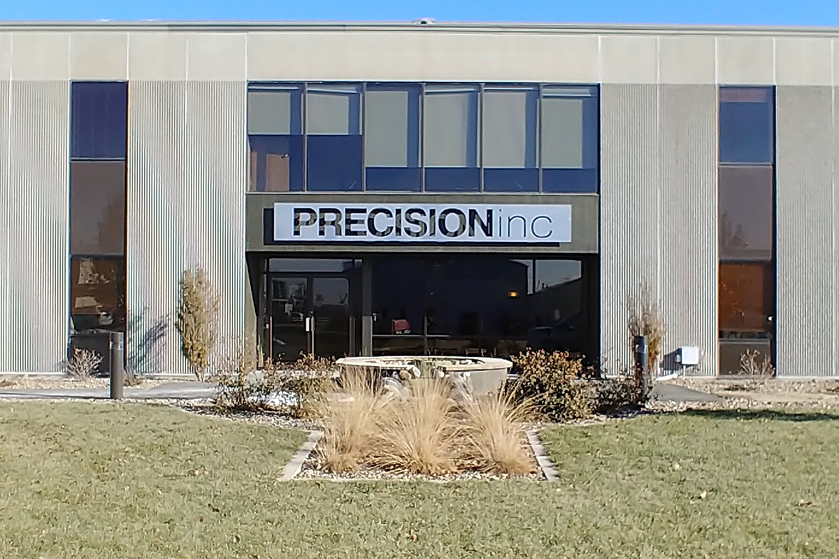 Aluminum wall-mounted storefront sign for Precision, Inc.