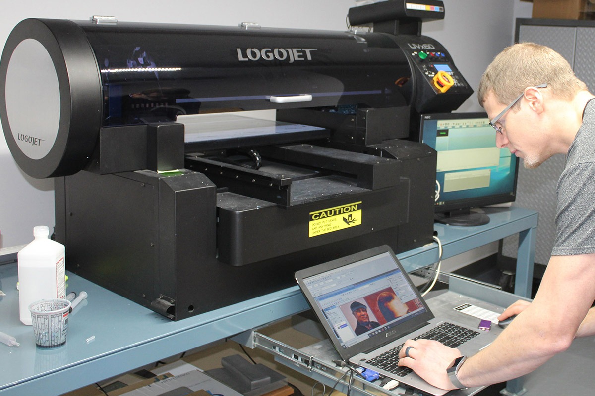 PEC team member programming UV flatbed printer
