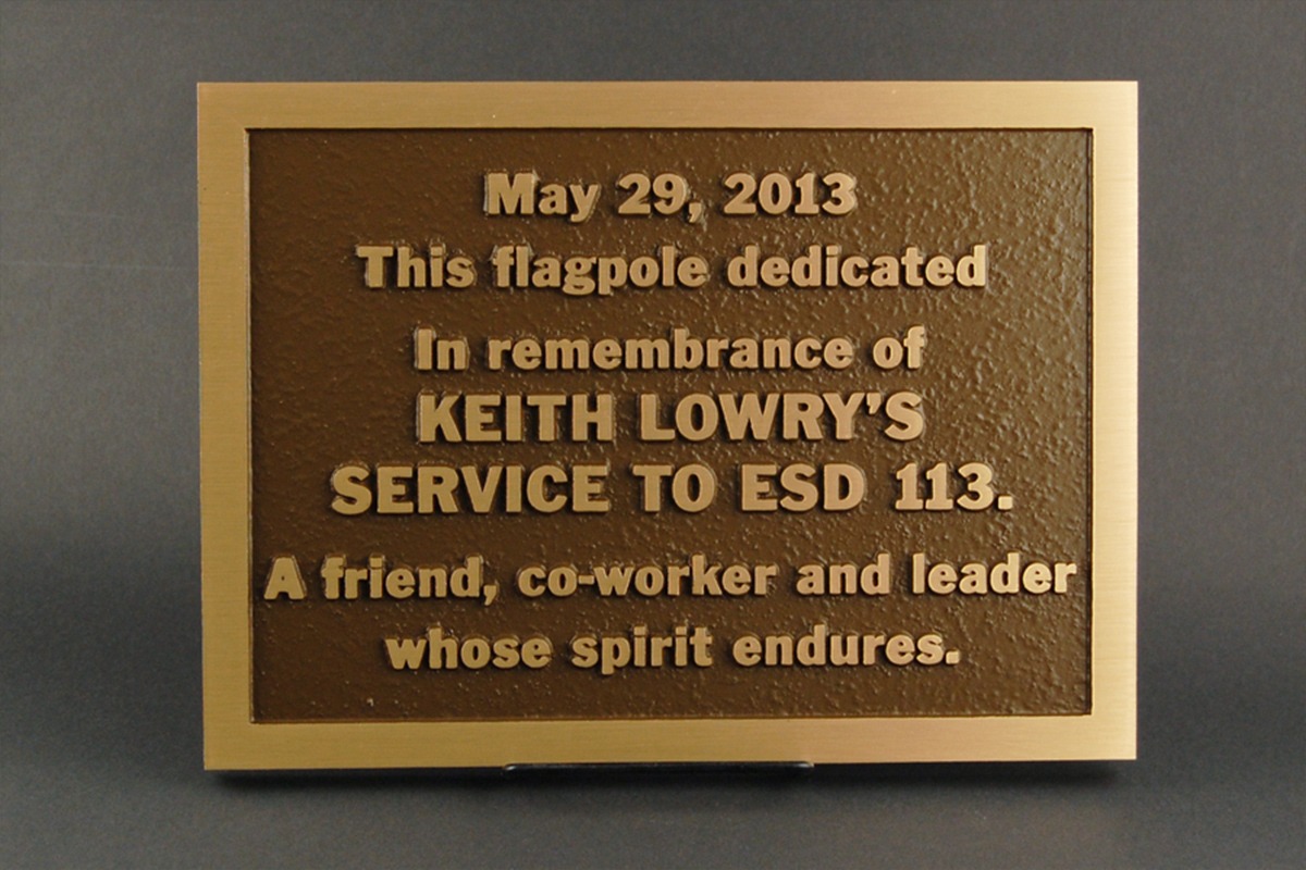 Bronze flagpole dedication plaque