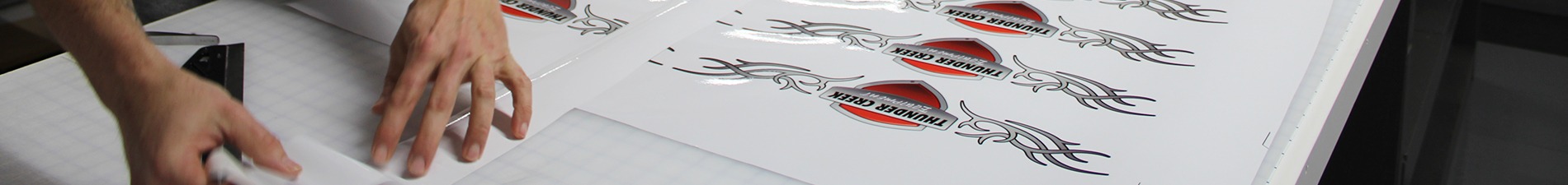 Header image with two hands cutting out Thunder Creek vinyl decals