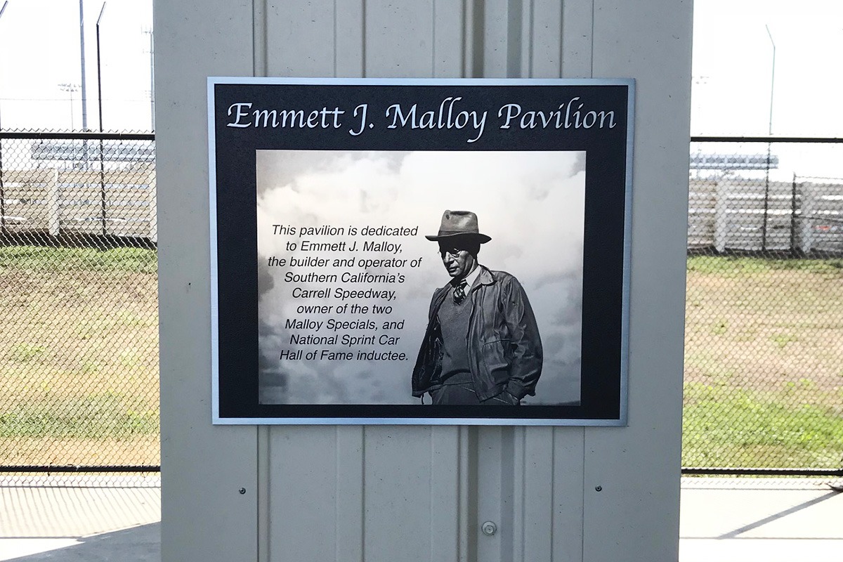 Outdoor directional architectural signage Malloy Pavilion, with dedication plaque