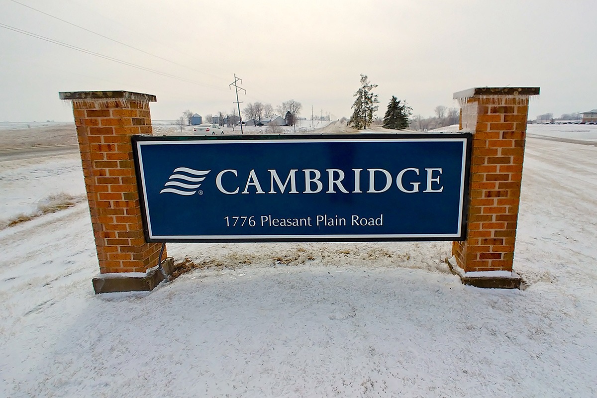 Freestanding blue Cambridge storefront sign with brick posts