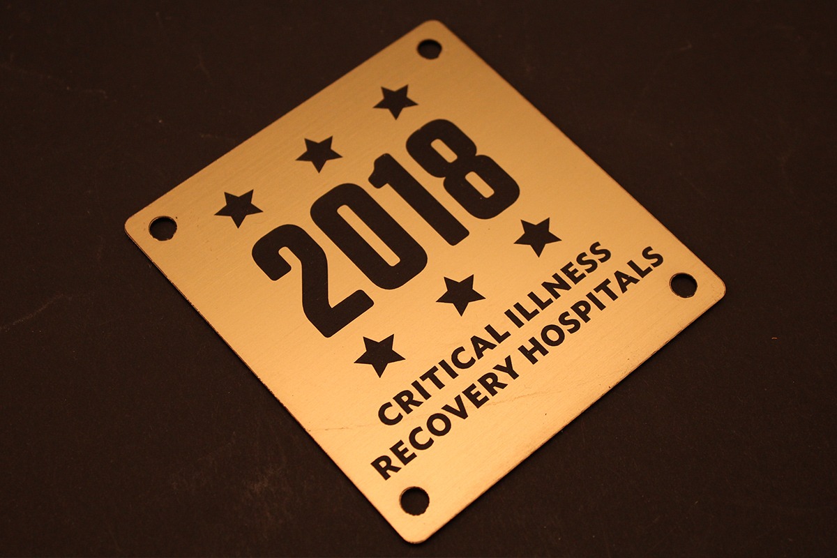 Laser-engraved or marked aluminum 2018 nameplate for Critical Illness Recovery Hospitals with stars