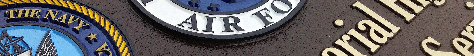 Header image with closeup of color-filled U.S. military seals on magnesium plaque