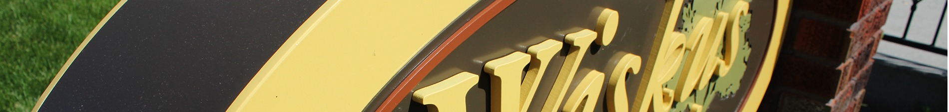 Header image closeup of freestanding Wiskus Group storefront sign