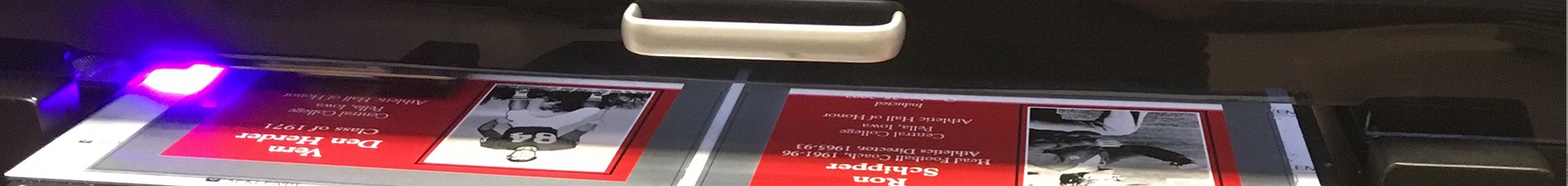 Header image of red plaques with black and white photos coming out of UV printer
