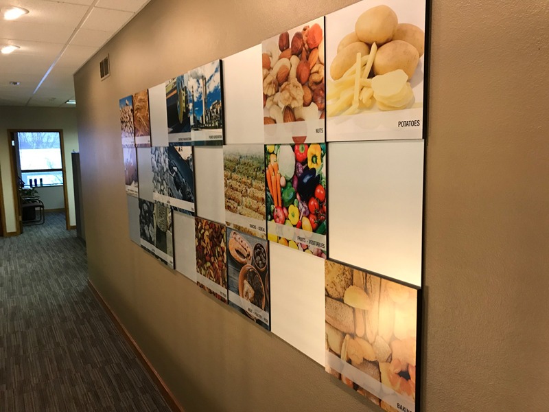 Wall of UV-printed aluminum tiles with colorful photos of food and outdoor scenes