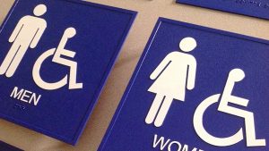 Closeup of blue and white bathroom signs
