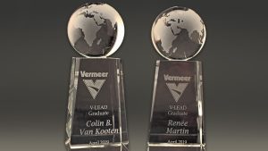 Two sandcarved awards with 3D globe and Vermeer logo